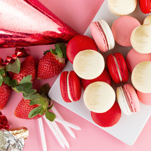 A close up of personalized cookies for birthdays along fresh strawberries 